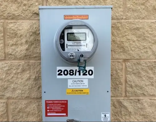 a grey electrical box with a round display