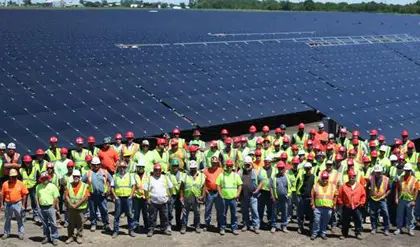 a group of workers in a solar farm