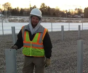 a man wearing a safety vest and a white helmet