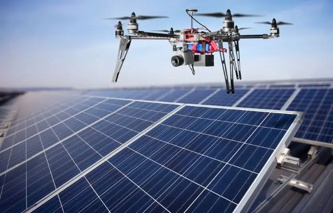 a drone flying over solar panels