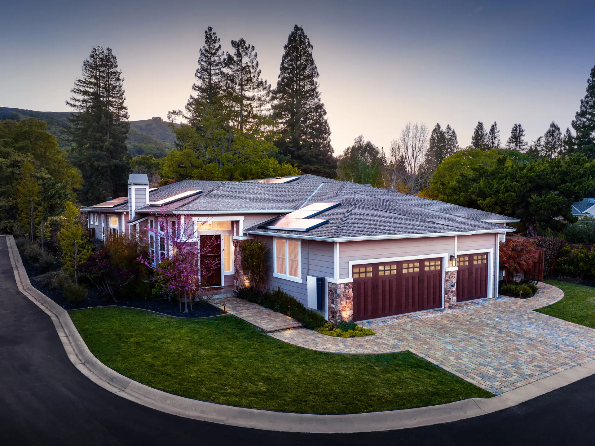 a house with a driveway and trees