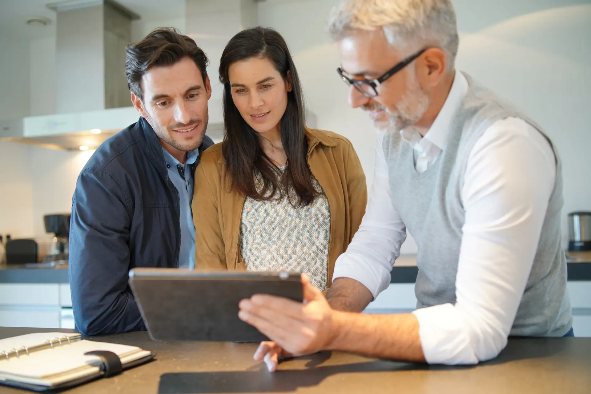 a group of people looking at a tablet