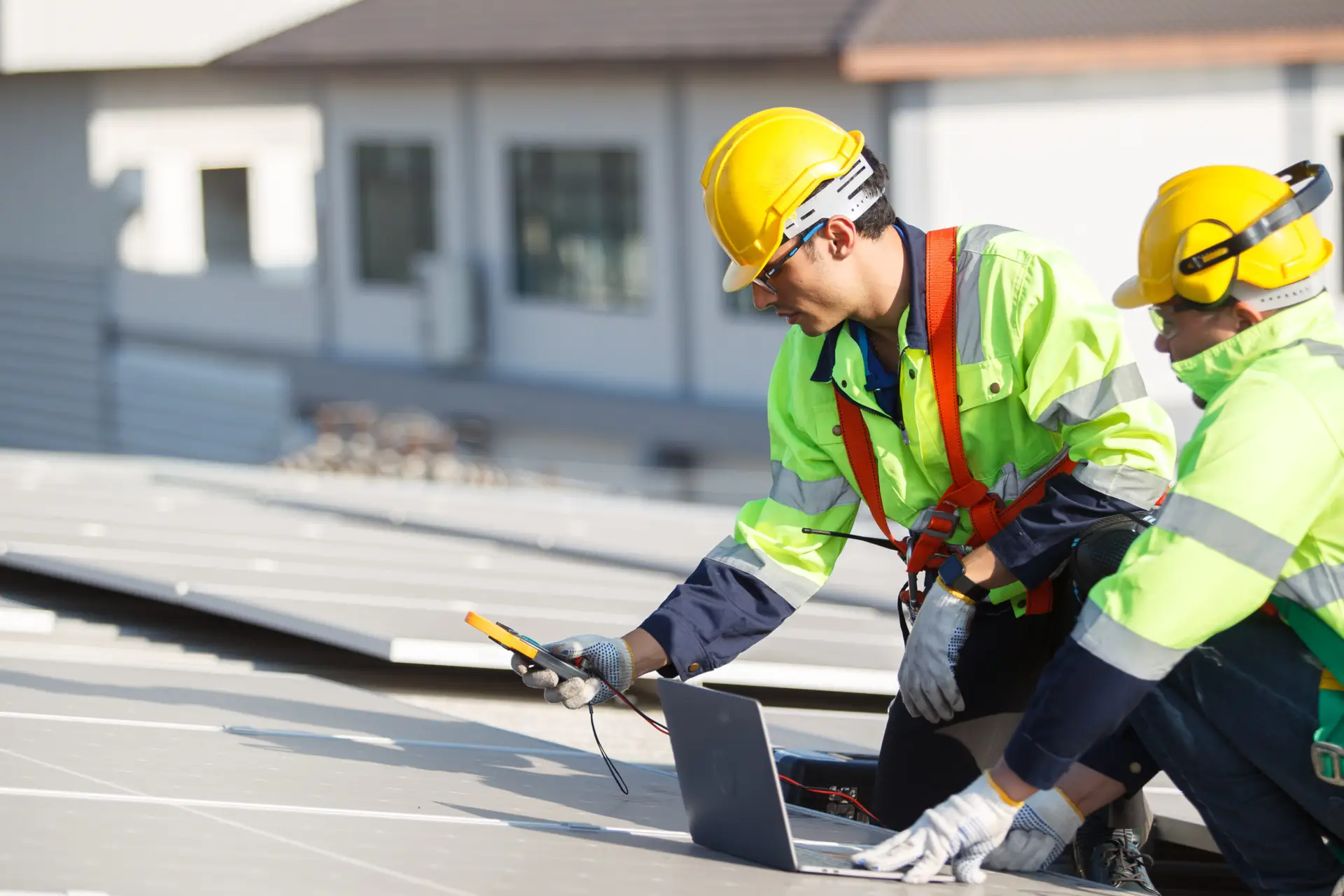 a man in safety gear using a laptop