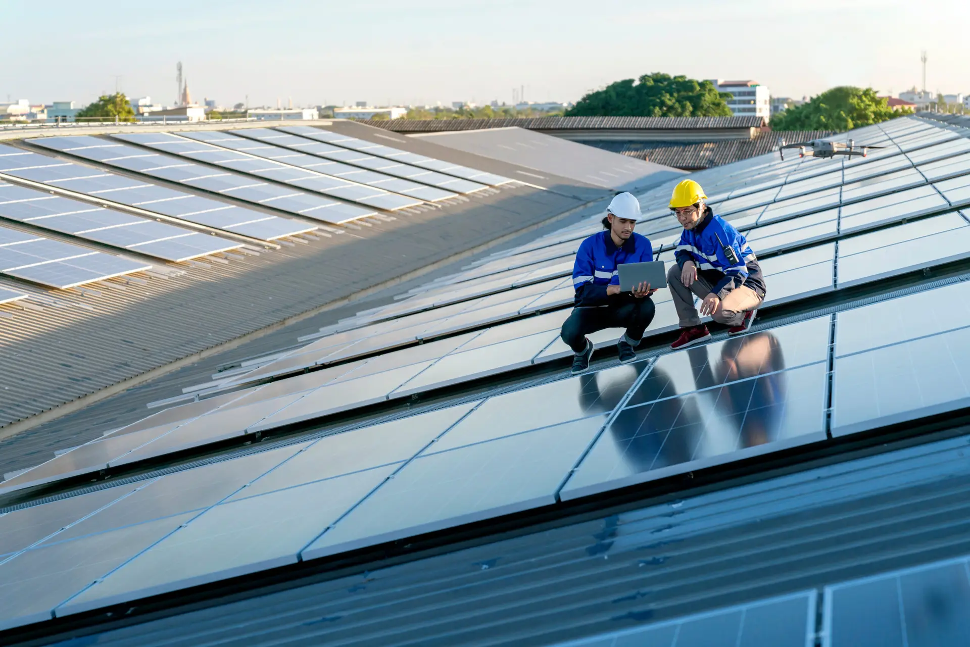 two men on a roof with solar panels