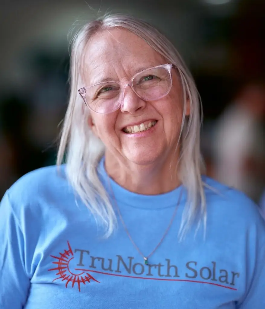 a woman wearing glasses and a blue shirt