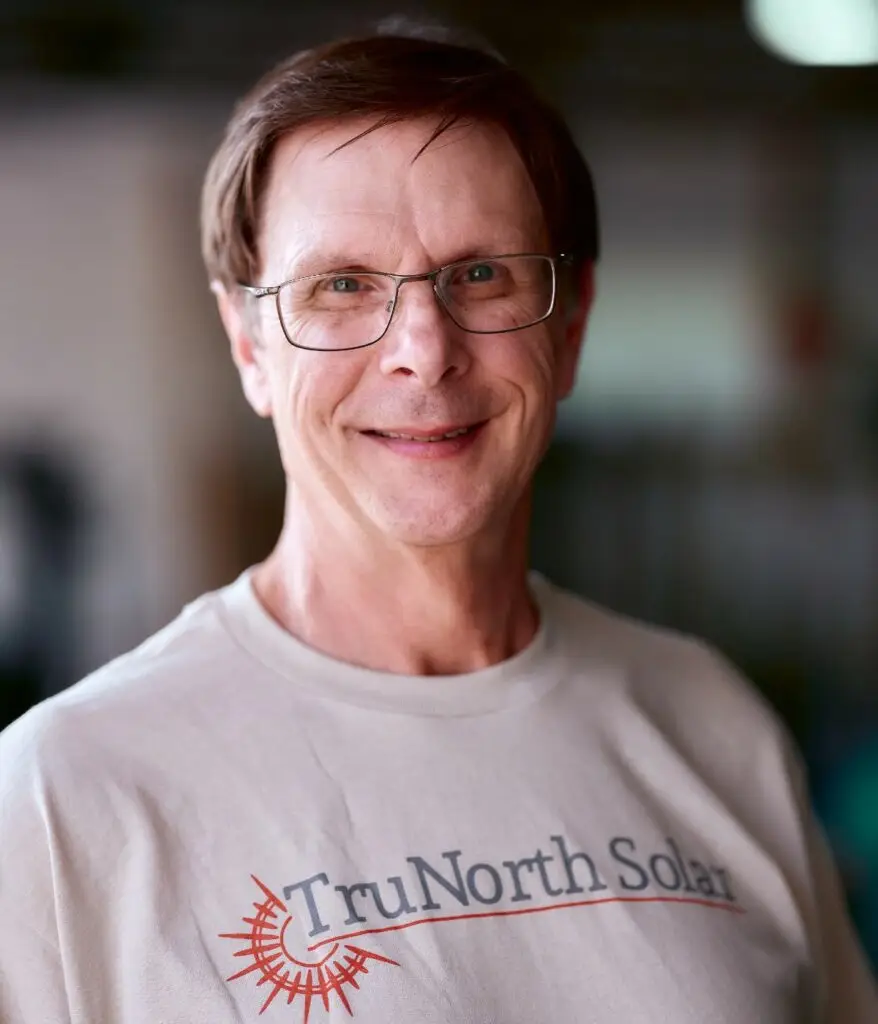 a man wearing glasses smiling