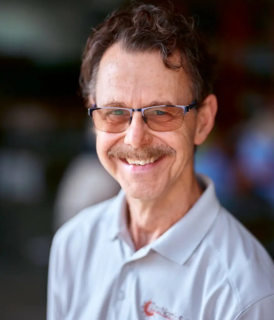 a man wearing glasses and a white shirt