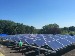 a man standing in front of a solar panel