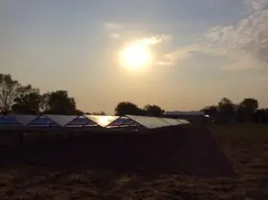 a group of solar panels in a field