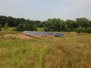 a field of grass with solar panels