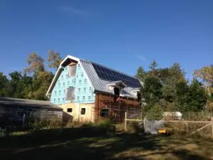 a house with a blue roof and a fence