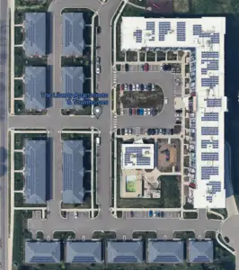 an aerial view of a building with parking lot and parking lot