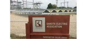 a sign with a fence and power lines