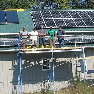 a group of men standing on scaffolding